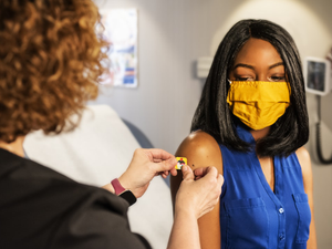 In this 2020 photograph, captured inside a clinical setting, a health care provider and patient, consult on influenza vaccine options. The best way to prevent seasonal flu illness is to get vaccinated every year. Centers for Disease Control and Prevention (CDC) recommends everyone 6-months of age and older get a flu vaccine every season. There are many vaccine options to choose from, but the most important thing, is for all people 6-months and older, get an influenza vaccine every year.