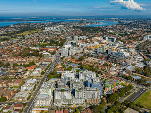 Aerial overview of Sydney metropolitan suburb with mixed-density housing, commercial infrastructure, and transport corridors, reflecting Australia’s evolving accommodation landscape and urban intensification.