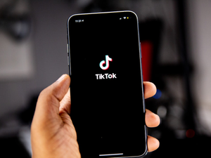 Person holding an iPhone running TikTok