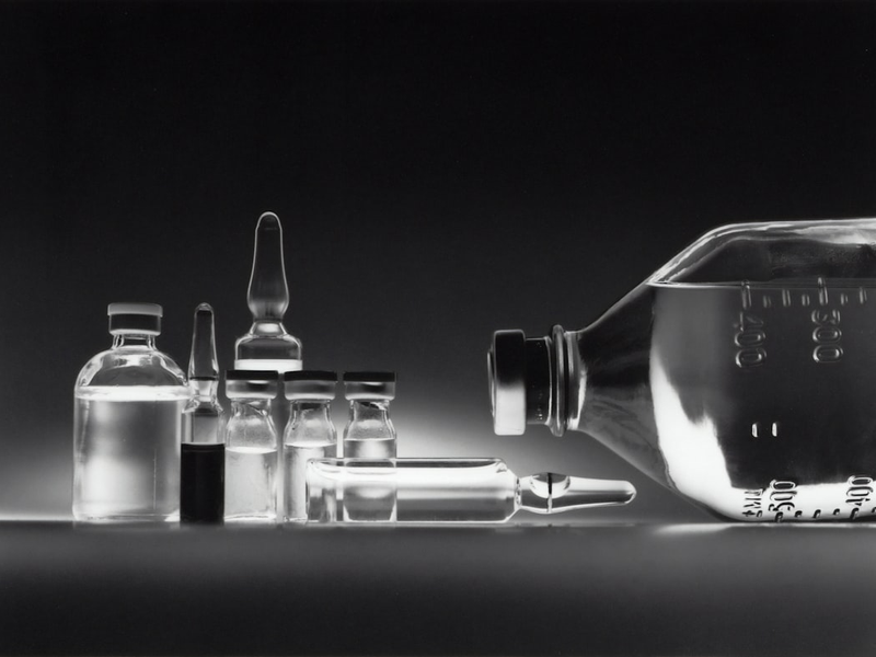 Variety of chemotherapy drugs in vials and an IV bottle.