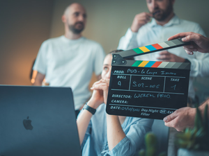 Filming a scene with a clapperboard and laptop