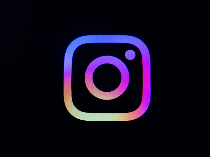 Instagram logo with colorful gradient on black