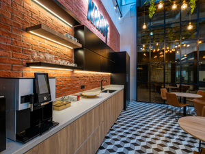 a coffee shop with a brick wall and a checkered floor