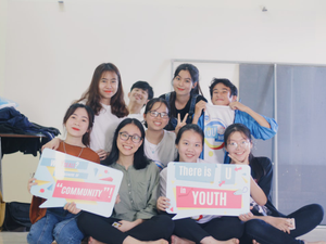 people holding banner taking pose