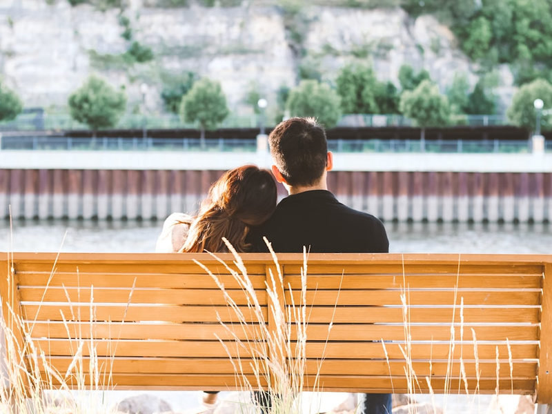 couple sitting on wooden bench