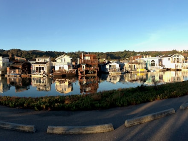 white and brown concrete building beside river during daytime