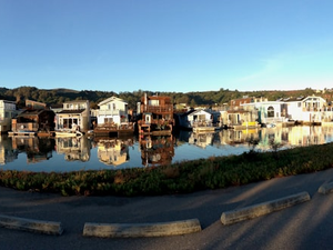 white and brown concrete building beside river during daytime