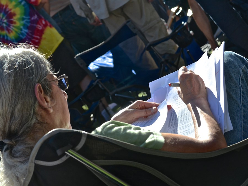 teacher grading papers during Hardly Strictly Bluegrass concert