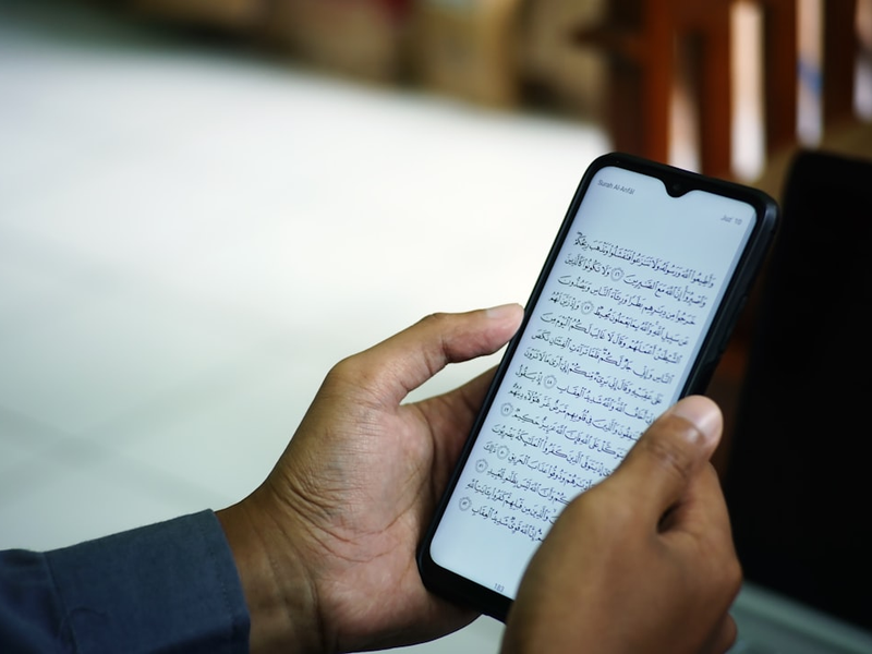 a person holding a smart phone in their hand