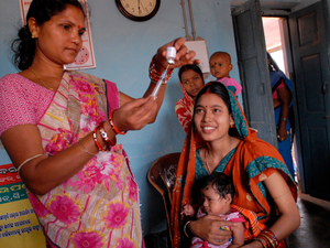 Community health worker gives a vaccination in Odisha state, India