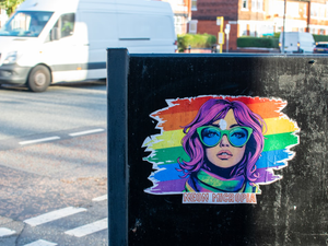 Sticker of a woman with purple hair and sunglasses.