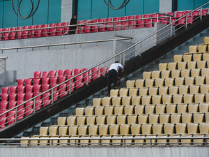 a man with an umbrella is standing on a set of stairs