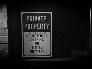 a black and white photo of a private property sign