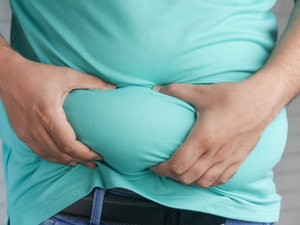 a man holding his stomach with his hands