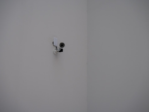 A security camera mounted in a white corner.