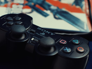 A PlayStation 2 controller, with a Metal Gear Solid II: Sons of Liberty game