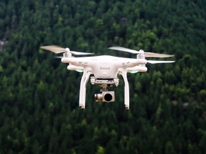 White drone mid-flight