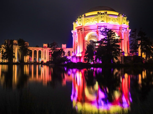 Grand building illuminated with colorful lights at night