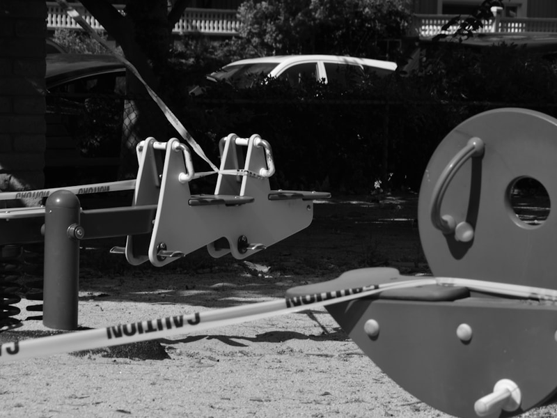 a black and white photo of playground equipment