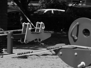 a black and white photo of playground equipment