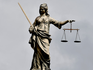 A statue of lady justice holding a sword and a scale