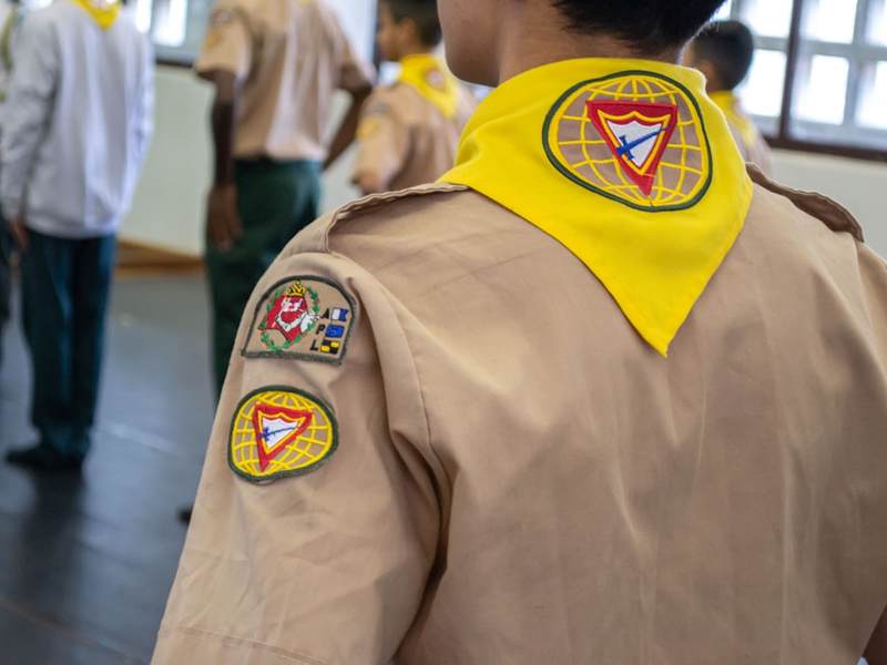 a person wearing a yellow jacket with a logo on it