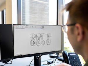 Male mechanical engineer designs agricultural robots