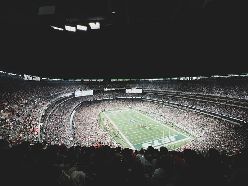 a stadium filled with lots of people watching a football game
