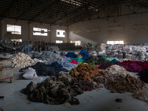 Sorting through hundreds of tons of clothing in an abandoned factory for a social mission called Clothing the Loop.