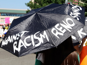 woman in black and white t-shirt holding black umbrella
