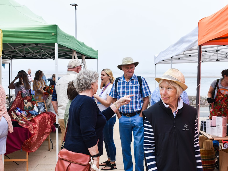 People enjoying a community event by the sea