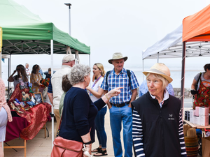 People enjoying a community event by the sea