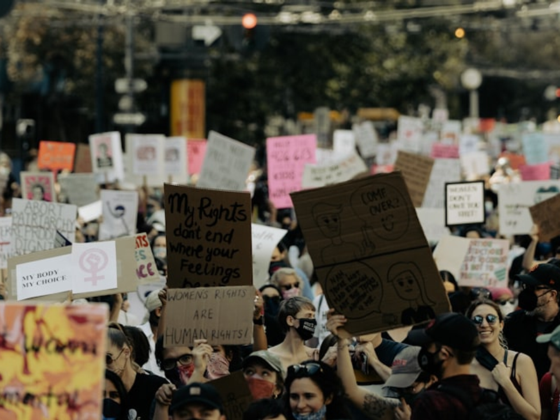 a large group of people holding up signs