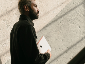 a man with a beard is holding a folder