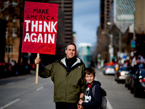 A man and his son peacefully protest the election of Donald J. Trump