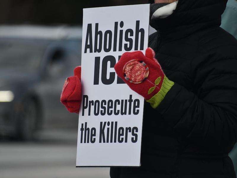 Person holding sign that says abolish ice prosecute the killers