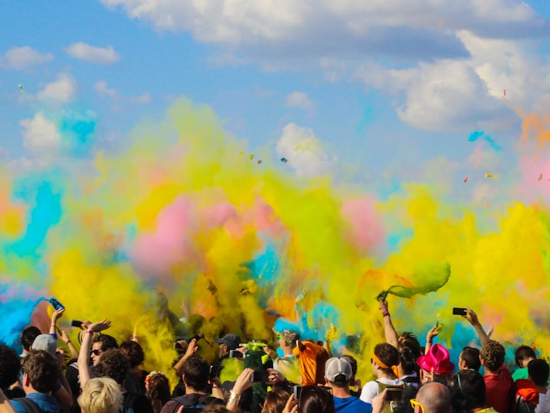 group of people celebrating powder festival outdoors