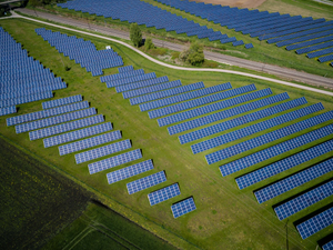 aerial photography of grass field with blue solar panels