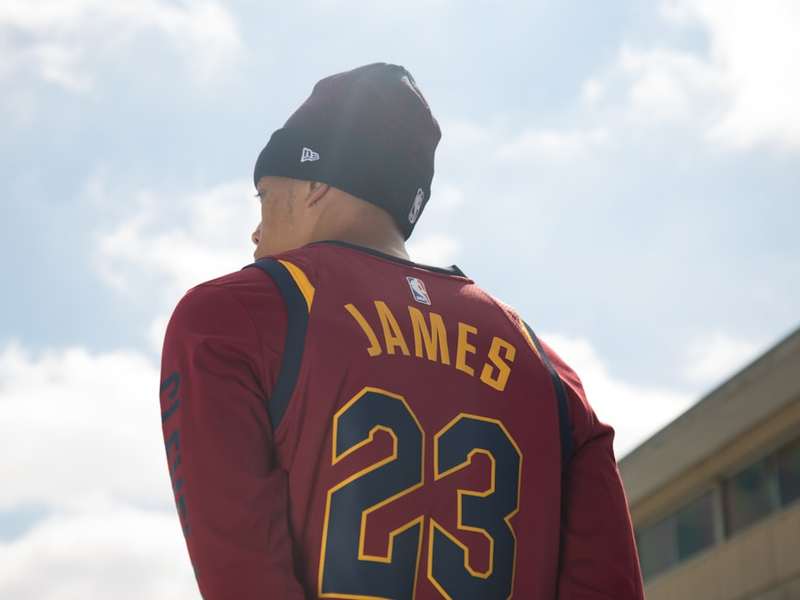 man in black and red long sleeve shirt wearing black cap