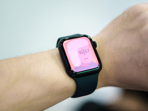 a close up of a person wearing a smart watch