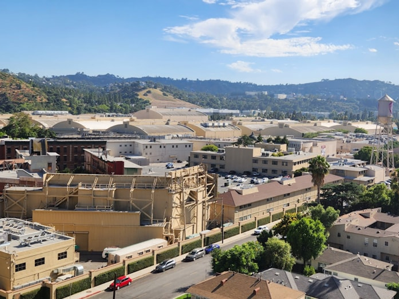 an aerial view of a city with mountains in the background