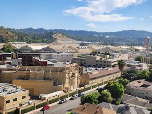 an aerial view of a city with mountains in the background