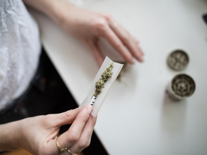 Woman make cannabis joint