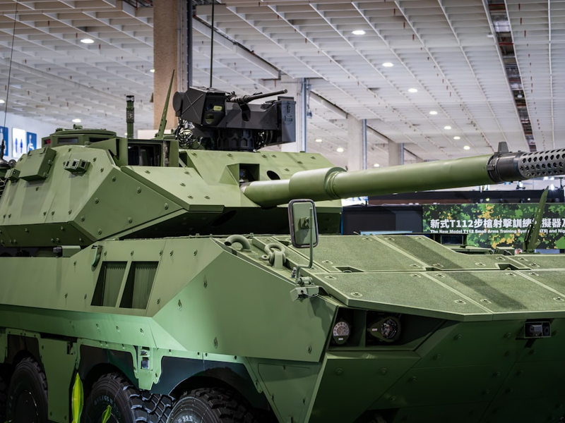 A green armored military vehicle with a large cannon.
