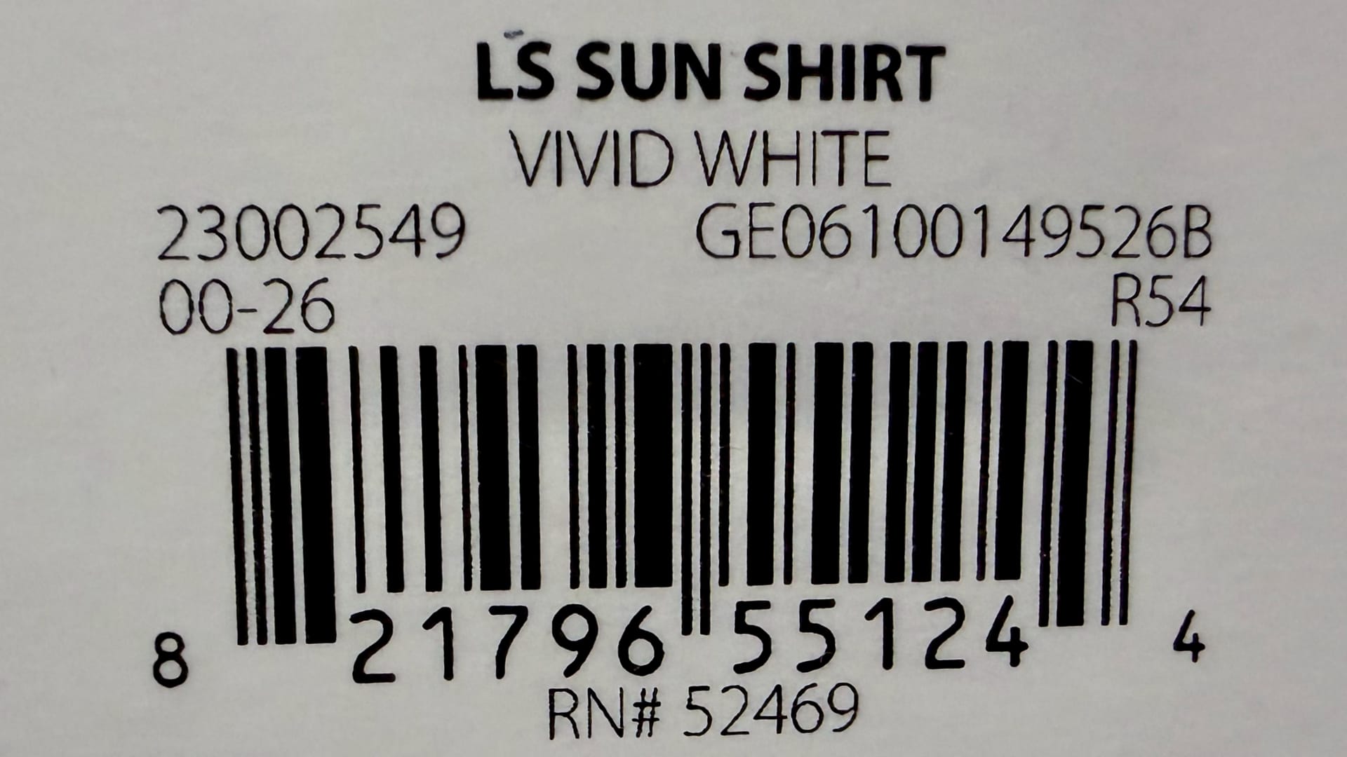 This image shows a close-up of a bar code label, which includes text like "LS SUN SHIRT" and "VIVID WHITE," along with a series of black and white lines.