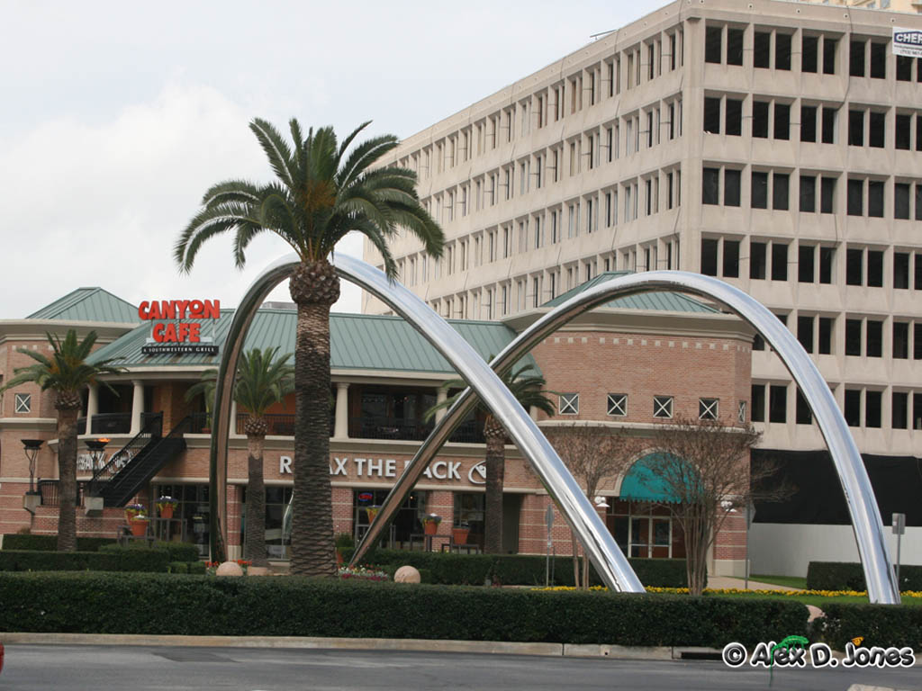 This picture shows tall metal arches that curve up and over like giant rainbows.