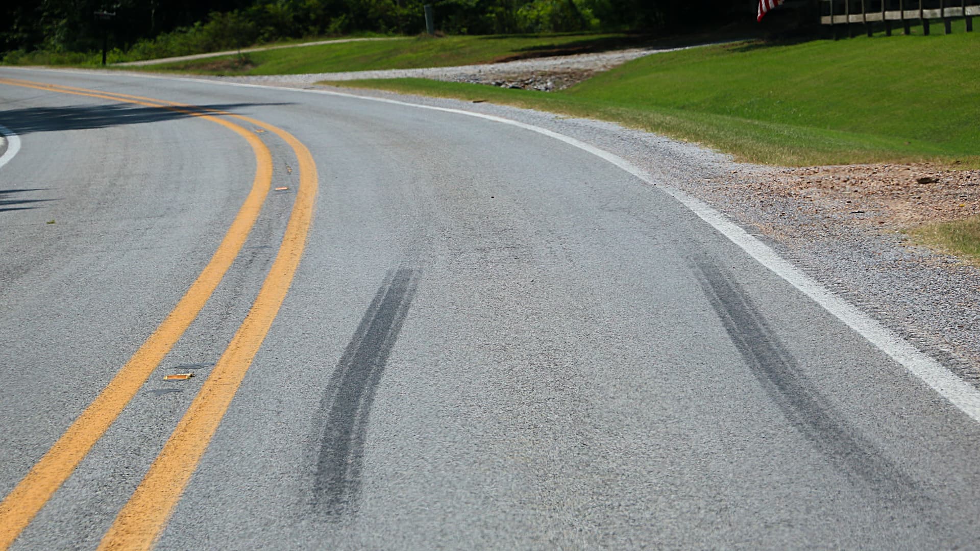This photo shows tire marks on a paved road. These dark marks are left behind when tires suddenly stop or turn quickly, creating friction.