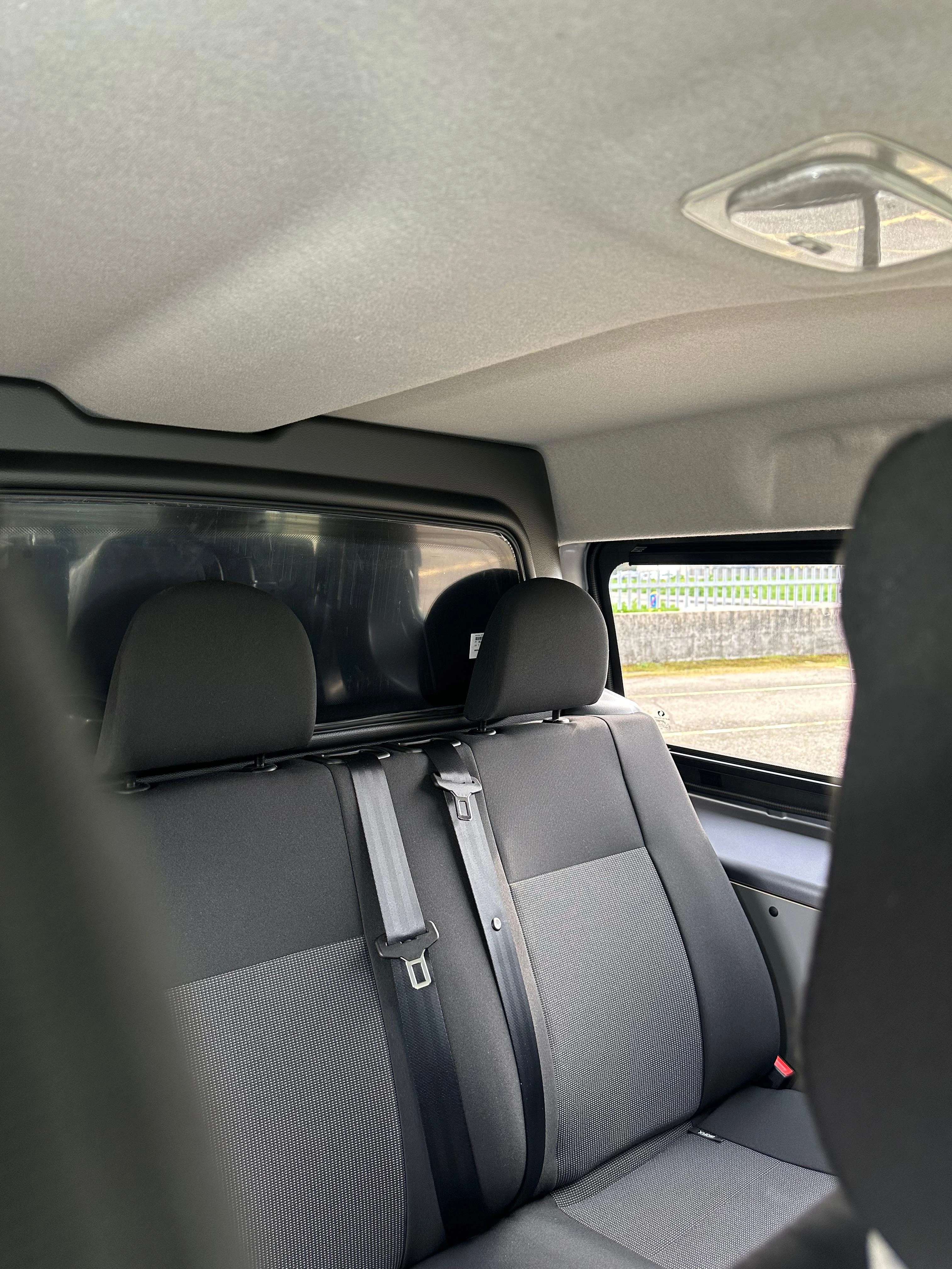 Interni di un furgone con sedili posteriori grigi.