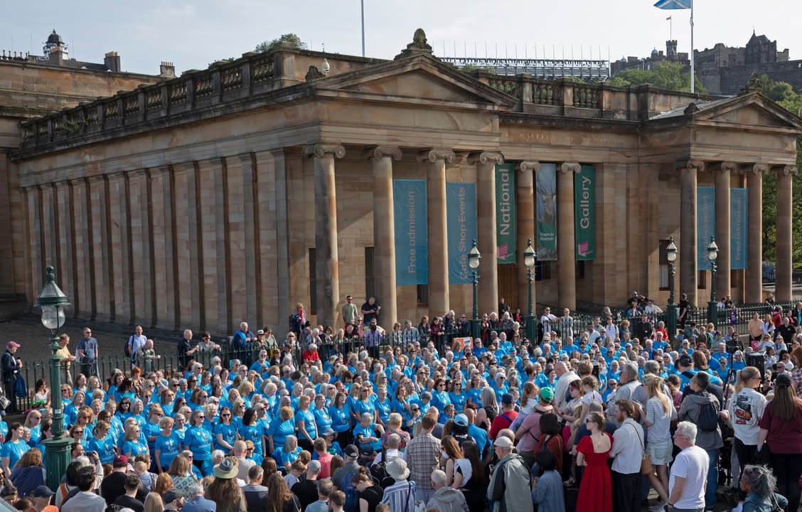 A cheerful group of people singing together in a warm community hall