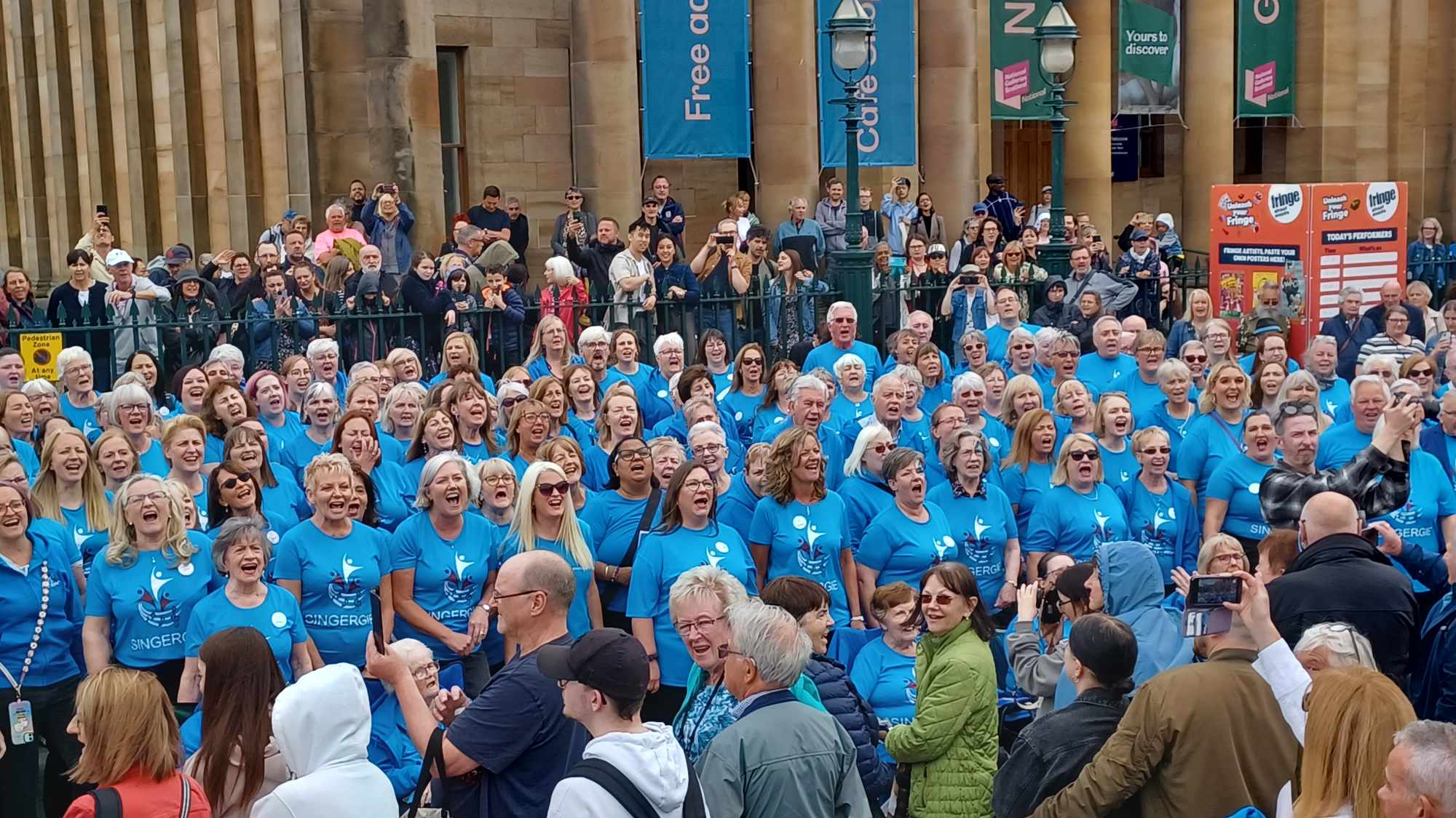A softly lit stage set up for a choir, with microphones and warm lighting